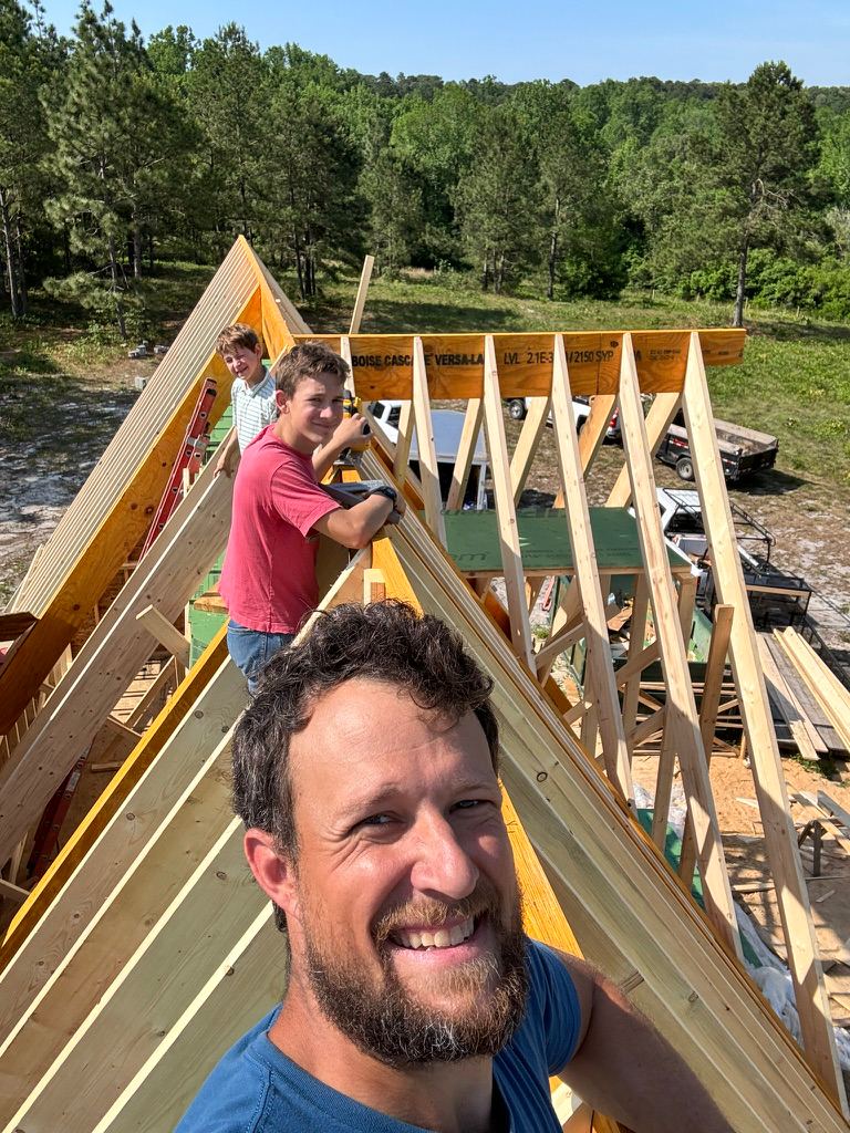 Nathan and his sons framing the roof of their dream home in Southern Pines